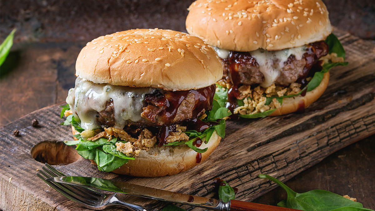 Burgers with Wing Sauce and Blue Cheese is made with Marie’s Super Blue Cheese.