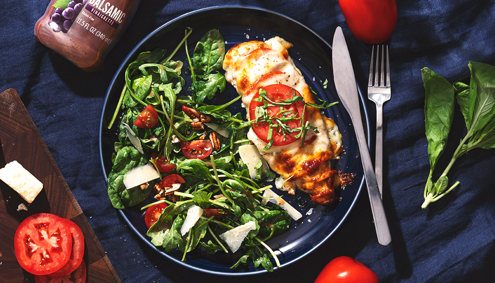 Balsamic Hasselback Caprese Chicken is made with Marie’s Balsamic Vinaigrette.