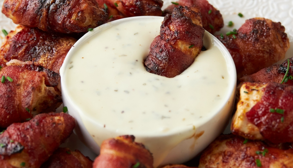 Chicken nuggets wrapped in bacon, dipped in ranch