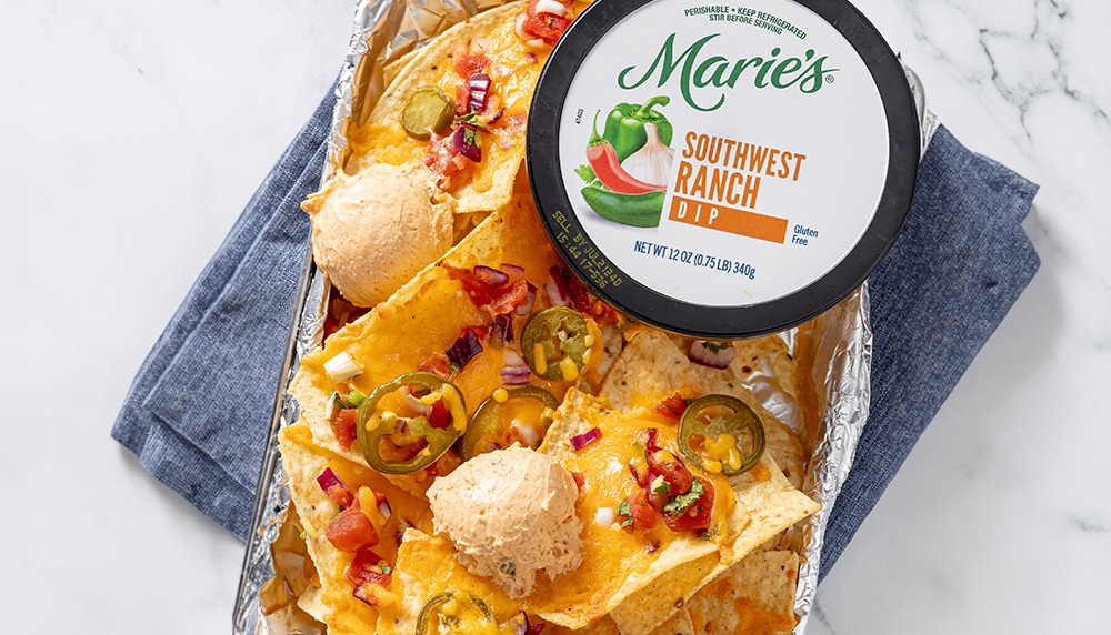 Plate of nachos with cheese, jalapenos and two scoops of Marie's Southwest Ranch Dip